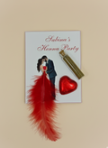 Henna party invitation with red feather, heart-shaped container, and couple illustration on a beige background
