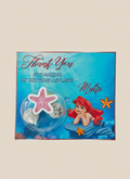 Mermaid-themed party favor with 'Thank You' card on a beige background