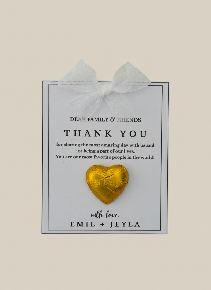 Heart-shaped chocolate on a card with 'Thank You' message, tied with a bow, on a beige background.