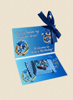 Blue birthday card with cartoon characters and a ribbon on a beige background