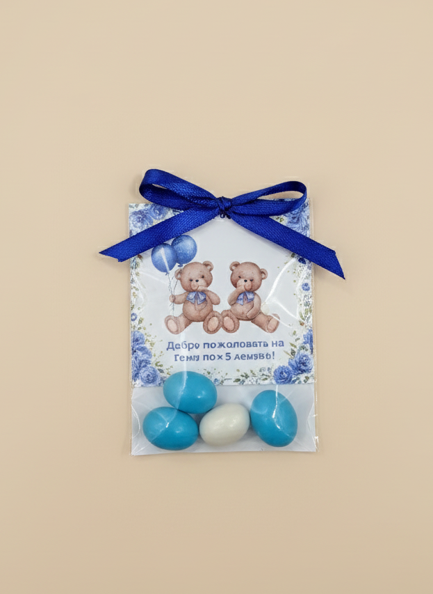 Gift bag with blue ribbon and teddy bear design on a beige background