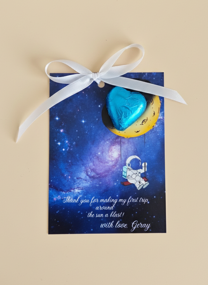 Greeting card with a blue heart-shaped object on a starry background, tied with a white ribbon.