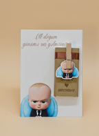 Card with a baby illustration and a small box on a beige background
