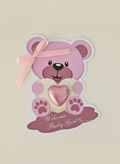 Pink teddy bear with a heart and 'Welcome Baby Girl' text on a beige background