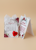 Calendar with floral design and red heart on a beige background