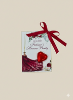 Invitation card for a Henna Party with a red dress and heart design, tied with a red ribbon on a beige background.