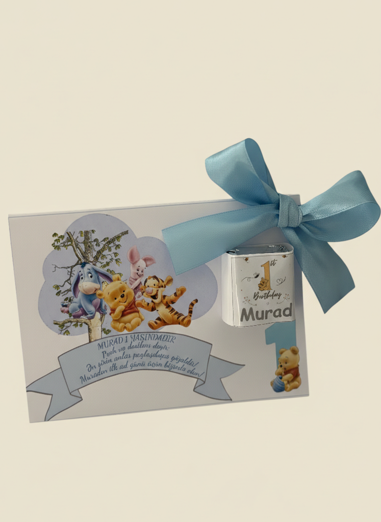 Gift box with a blue ribbon and Winnie the Pooh design on a beige background