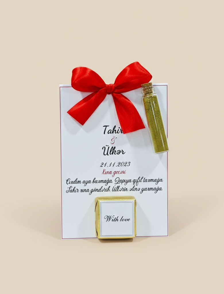 Gift bag with a red bow and a small bottle henna on a beige background