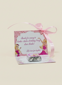 Pink candy bag with Barbie-themed design and a pink ribbon on a beige background