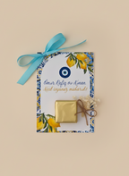 Decorative card with gold box and blue ribbon on a beige background