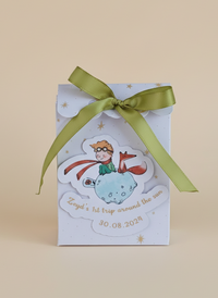 Gift box with a green ribbon on a beige background