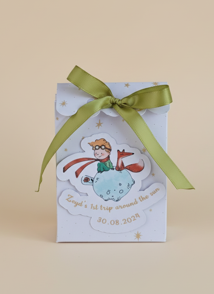 Gift box with a green ribbon on a beige background
