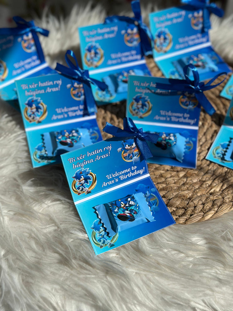 Blue birthday invitations with a cartoon character on a fluffy white surface