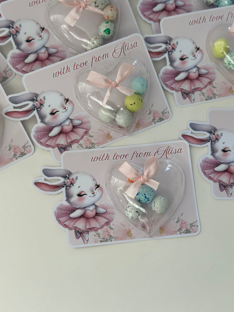 Stickers with cartoon bunny design and heart-shaped gift on a white surface