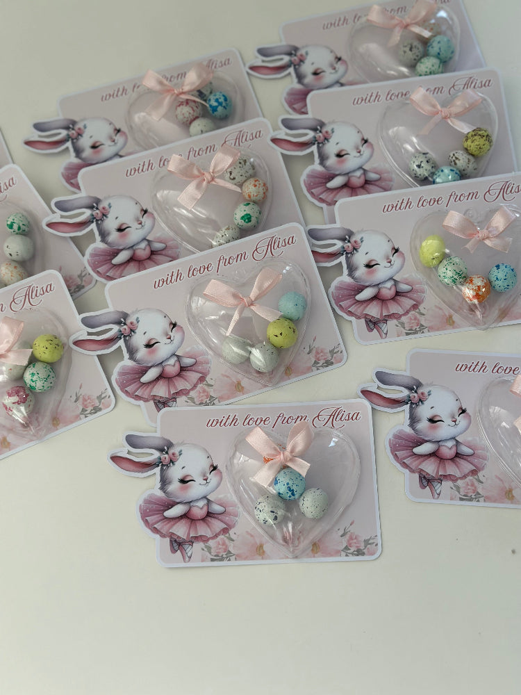 Set of cards with cartoon bunny designs and small decorative items on a light background