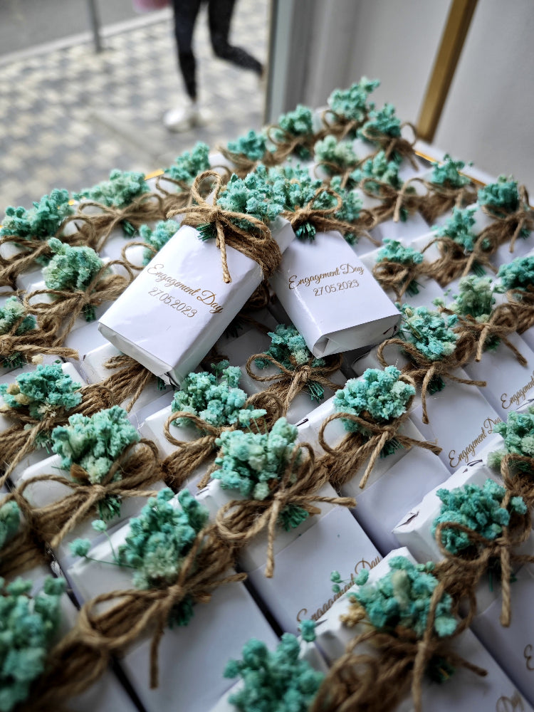 White books tied with greenery and twine on a white surface