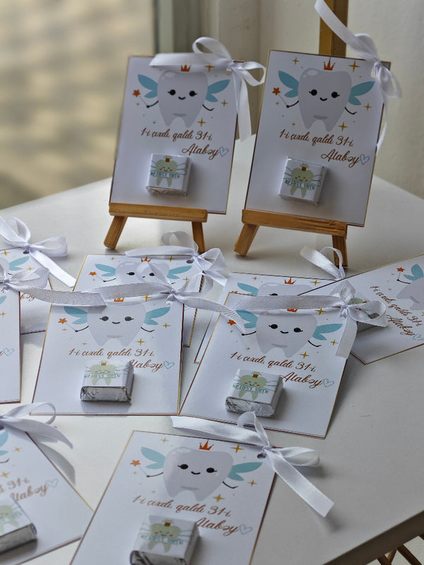 Small boxes with tooth designs on a white surface