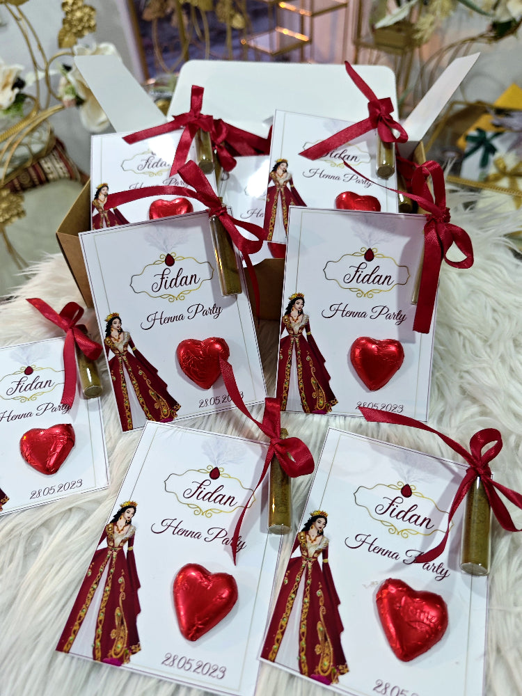 Favor bags with red ribbons and heart-shaped decorations on a decorative surface.