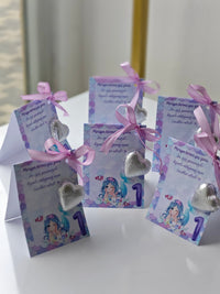 Decorative cards with ribbons and heart-shaped decorations on a white surface.