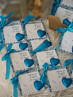 Decorative cards with blue hearts and ribbons on a textured surface