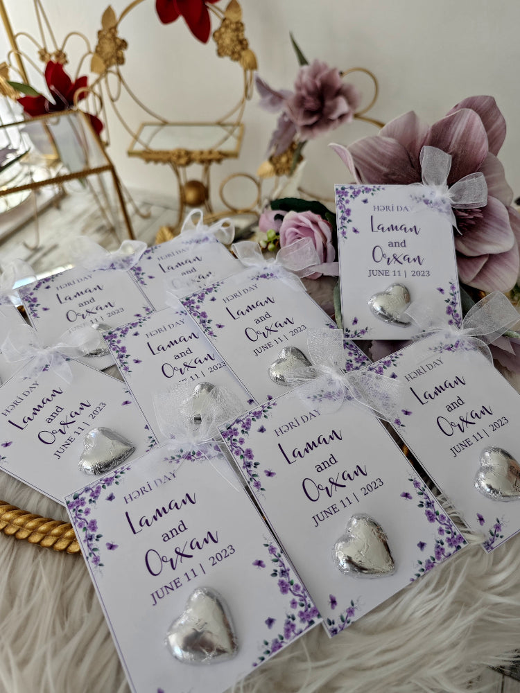 Heart-shaped earrings on personalized cards with floral designs and text.