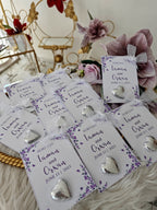 Heart-shaped earrings on personalized cards with floral designs and text.