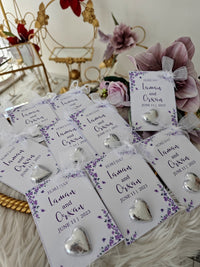 Heart-shaped earrings on personalized cards with floral designs and text.