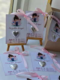 Heart-shaped chocolate on display with decorative cards and ribbons.