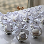 Decorative items with white ribbons on a table