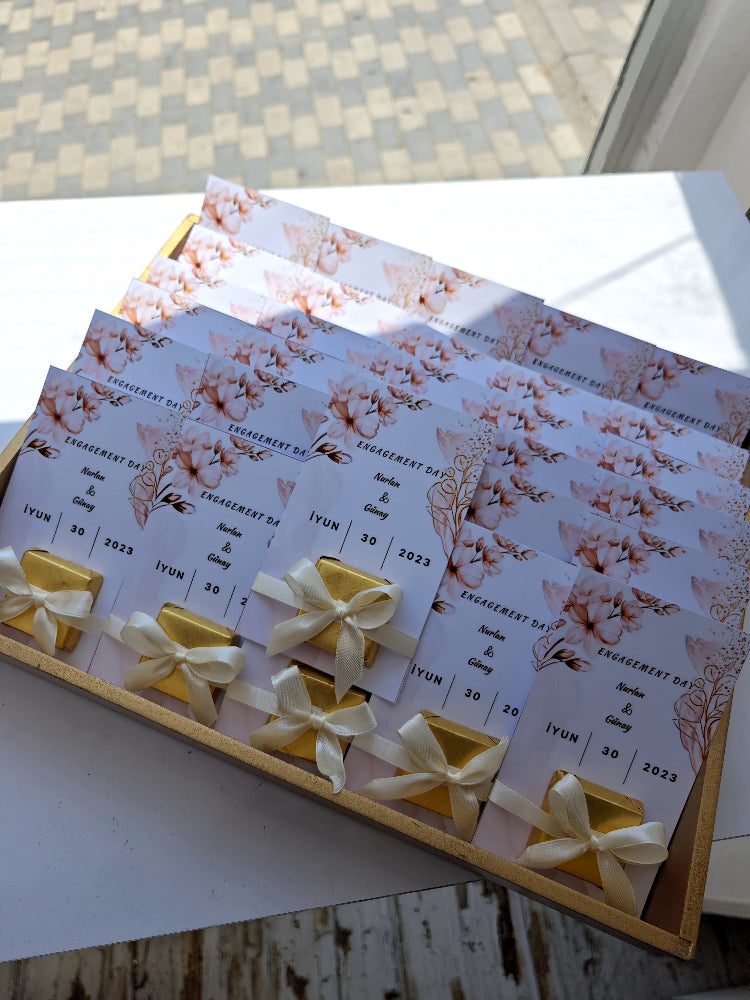 Set of floral wedding invitations with ribbons on a white surface