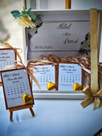 Wedding save the date cards with ribbons and flowers on a white surface