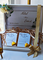 Wedding invitation set with calendar and ribbons on a white surface
