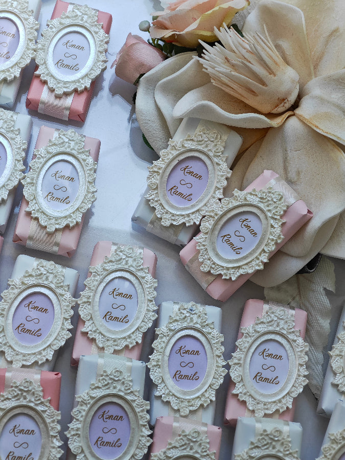 Decorative soap bars with ornate frames and personalized names on a white background.