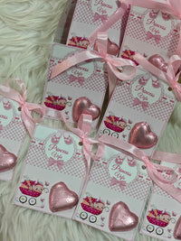 Set of 'Princess Viva' cards with pink ribbons on a fluffy white surface