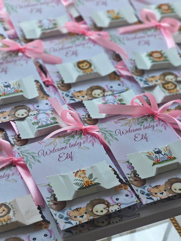Baby shower favor bags with lion designs and pink ribbons on a white background
