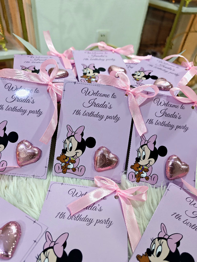 Invitations for a birthday party with Minnie Mouse design and pink ribbons.