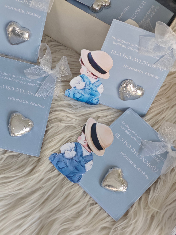 Heart-shaped earrings on cards with a decorative bow on a textured surface