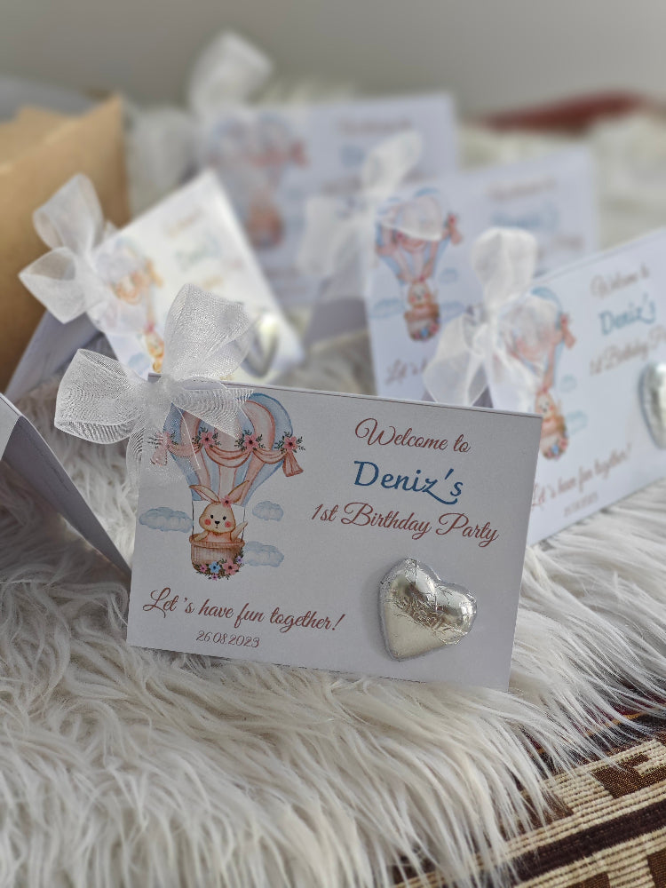 Heart-shaped earring on a birthday party invitation card with decorative elements.