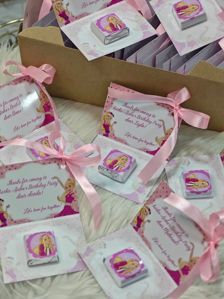 Collection of birthday party invitations with pink ribbons and princess design on a textured surface.
