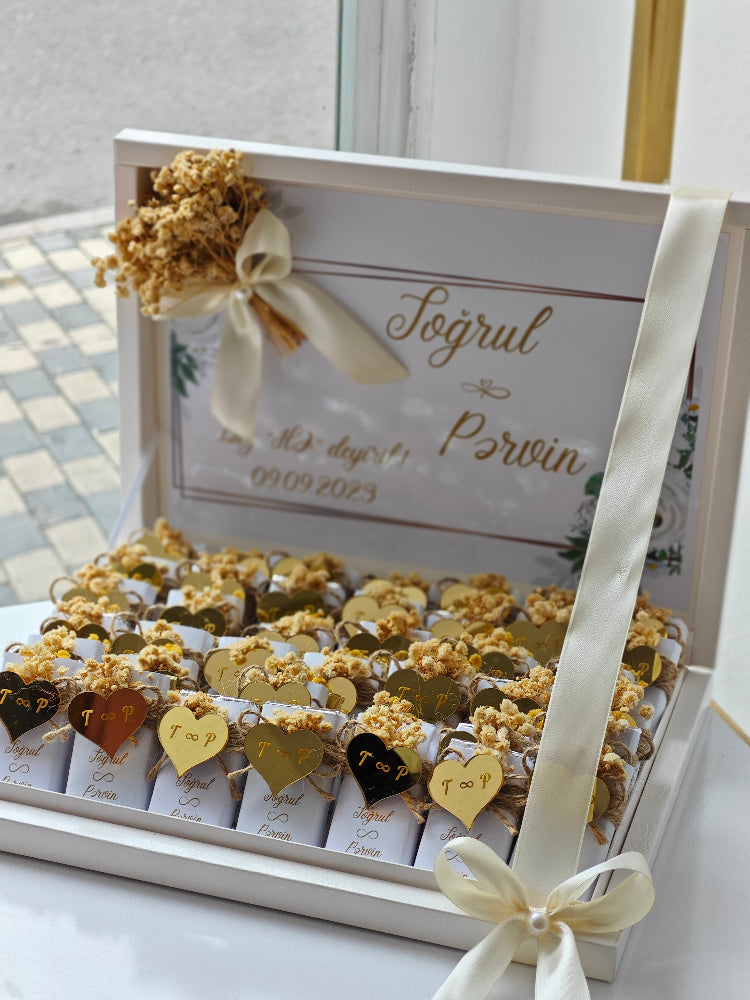 Decorative box with popcorn and small bags, tied with ribbons on a light background