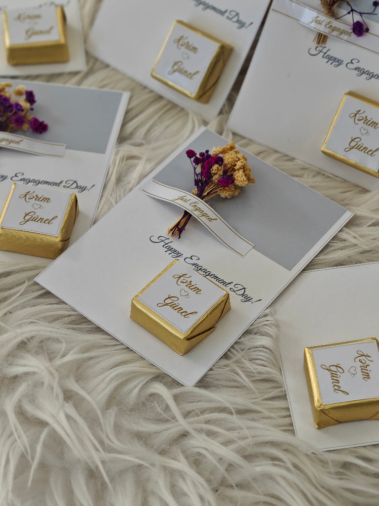 Engagement-themed cards with gold boxes and decorative elements on a textured surface