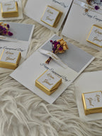Engagement-themed cards with gold boxes and decorative elements on a textured surface