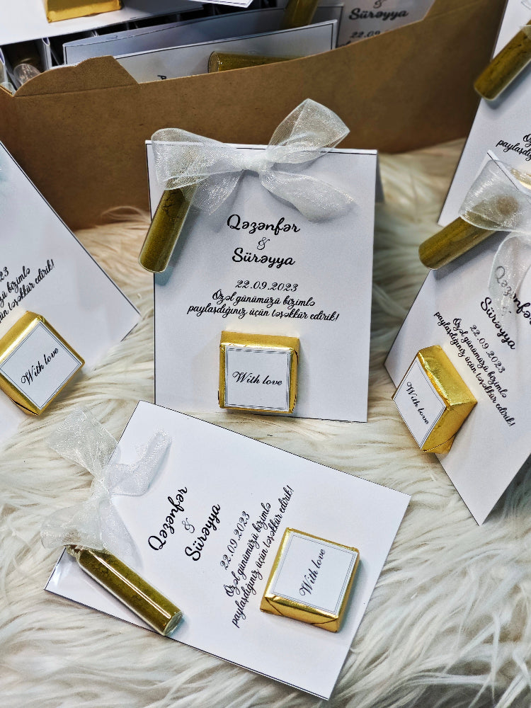 Personalized wedding cards with gold accents on a textured surface