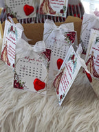 Decorative calendar with floral and heart designs on a fluffy surface