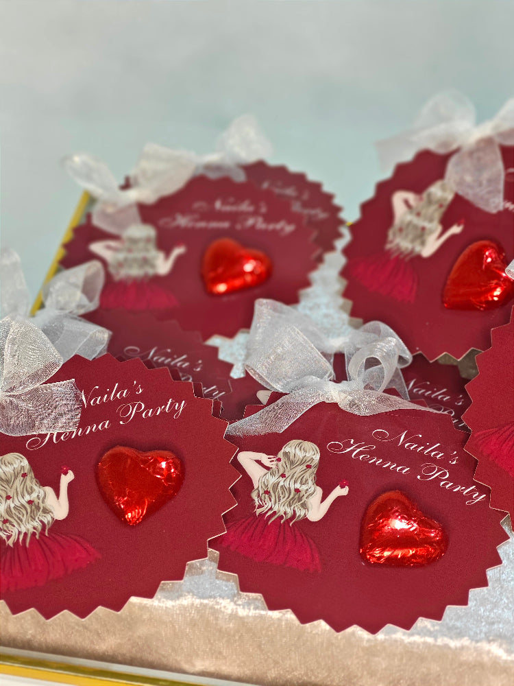 Red heart-shaped cards with 'Naila's Henna Party' text and illustrations on a light blue background.