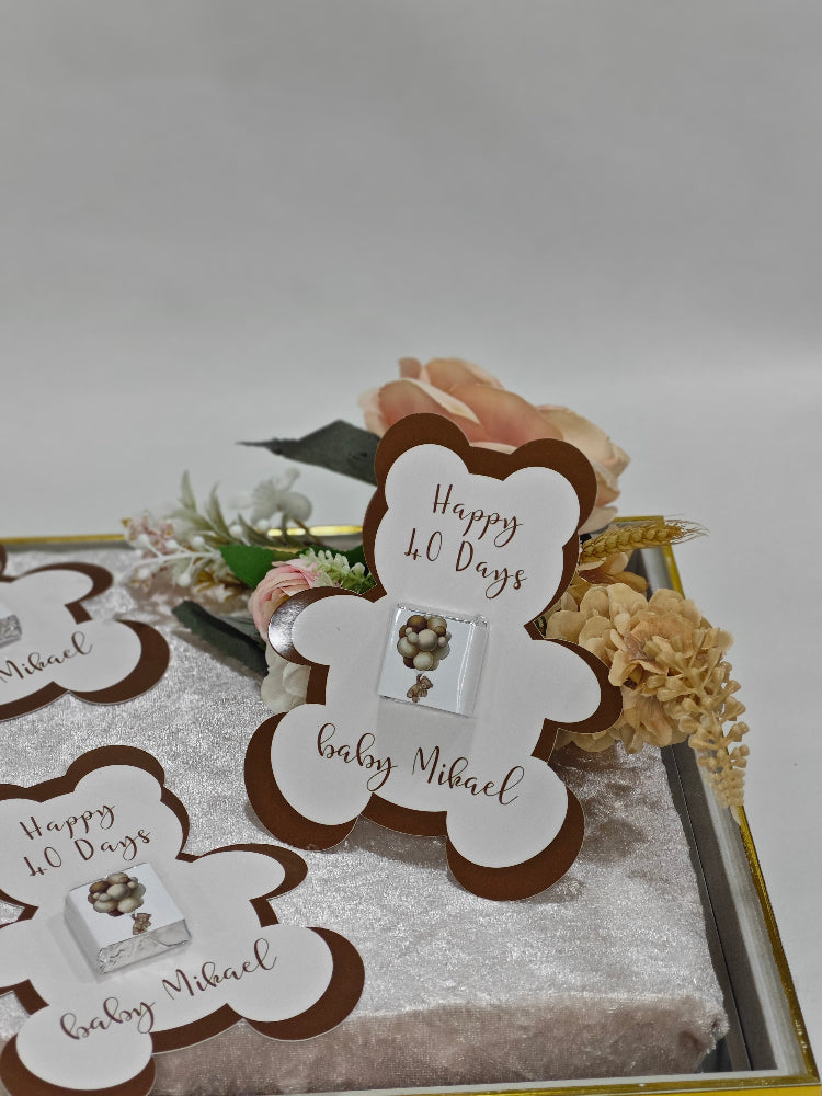 Baby shower invitation with teddy bear design and text on a decorative card.