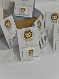 Party favor boxes with lion design and text on a white background