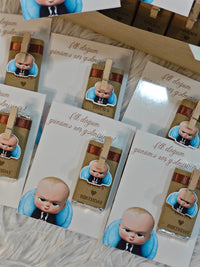 Set of birthday invitations with a cartoon baby character on a textured surface.