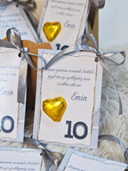 Decorative cards with gold hearts and ribbons on a textured surface