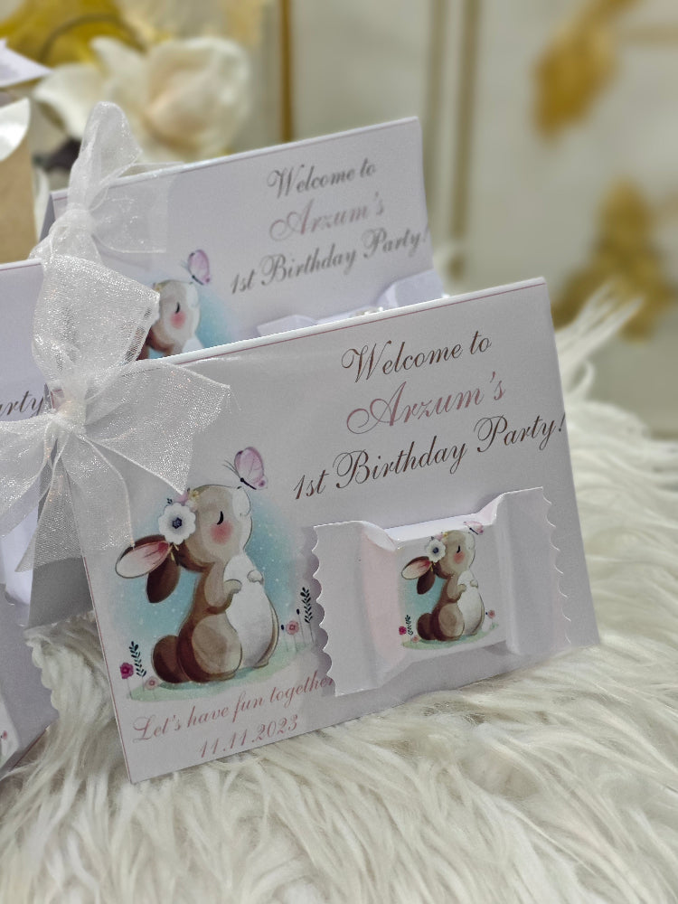 Children's birthday party invitation with rabbit illustration on a fluffy white surface